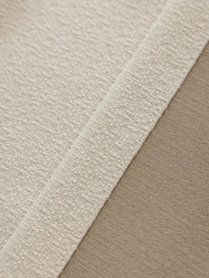 Close-up of fabric with white border, meticulously crafted with high-quality yarn for durability and a smooth drape, weighing 1100g.