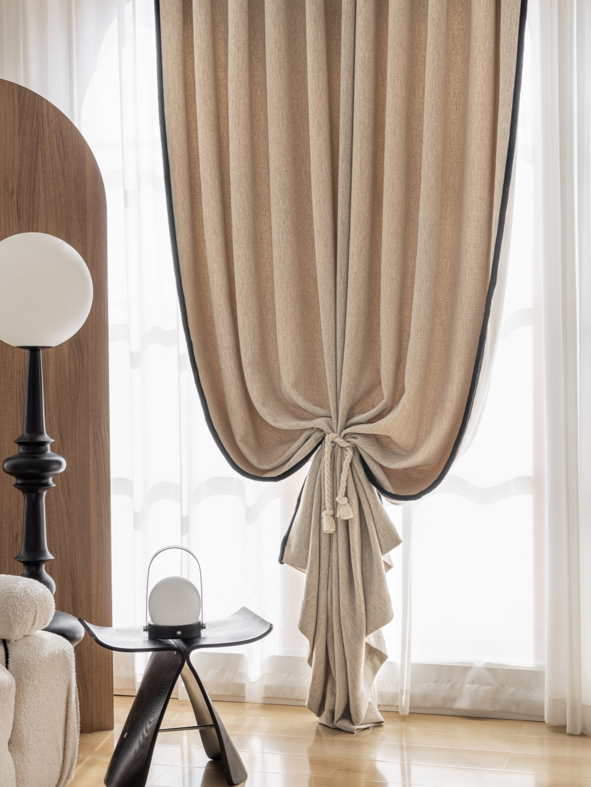 Elegant heavyweight chenille pleated curtain in taupe, tied back in a luxurious bedroom setting with contemporary decor