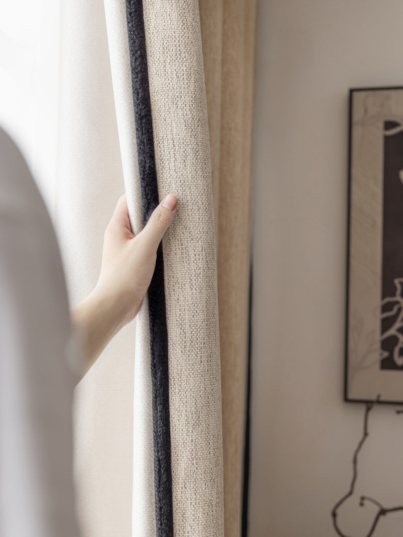 Woman holding curtain in front of window, showcasing EaseEase Luxury Heavyweight Chenille Drapery Pleated for Bedroom.