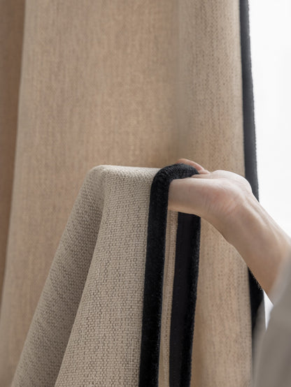 Close-up of luxurious heavyweight chenille drapery in neutral tones, showcasing the textured weave and quality fabric, ideal for elegant bedroom decor
