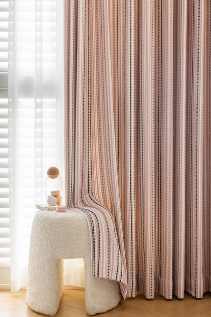 Striped curtains with Fair Isle jacquard pattern in playroom setting.