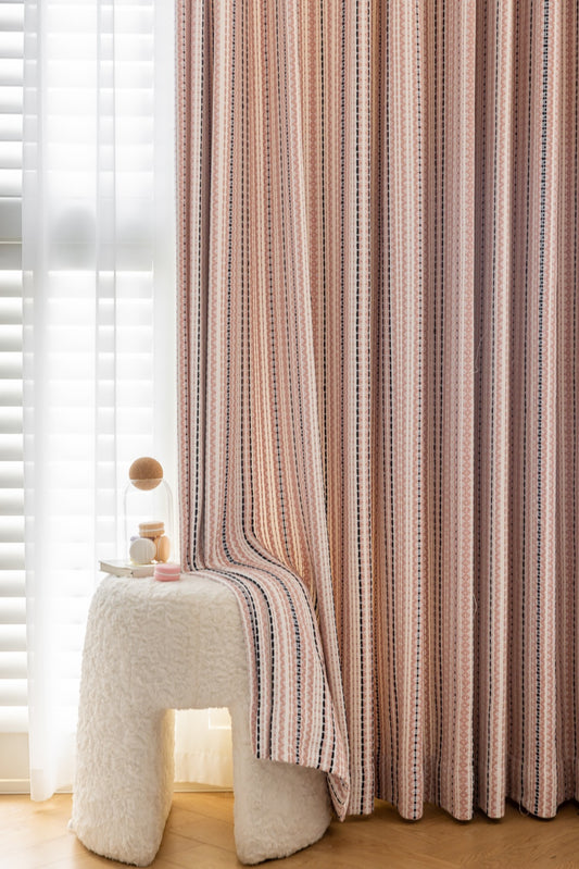 Striped curtains with Fair Isle jacquard pattern in playroom setting.