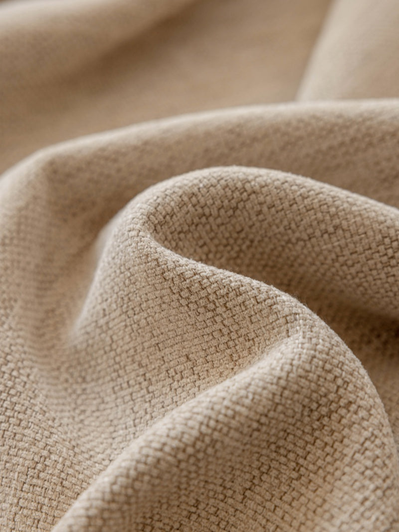A close-up of a beige fabric with a captivating variegated effect, crafted with a substantial weight of 1500g.