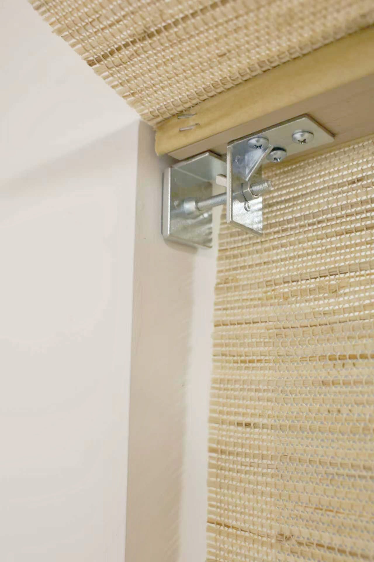 Beige natural ramie woven wood blinds with metal mounting bracket close-up