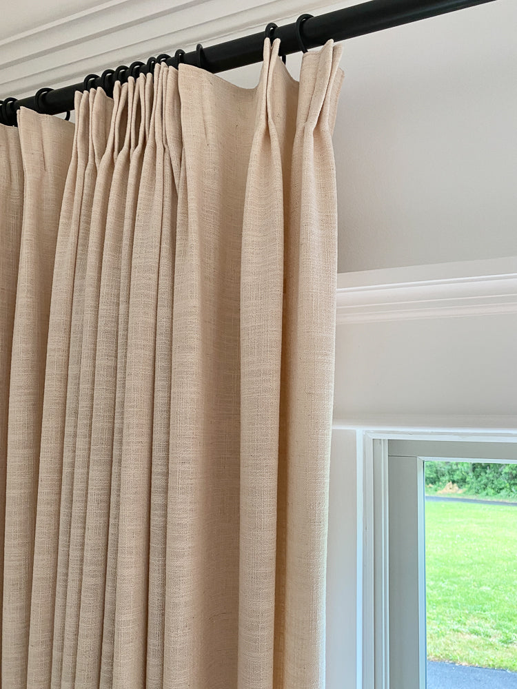 Linen blackout curtains in beige, enhancing home decor with style and functionality.