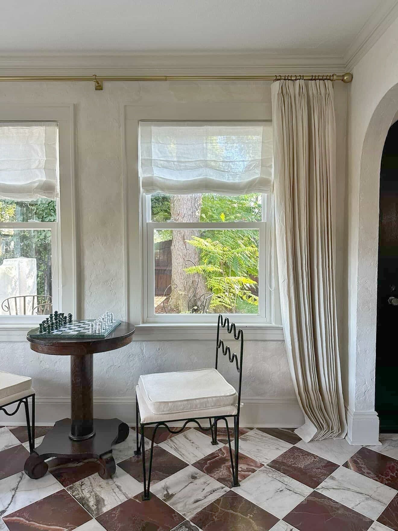 Soft sheer Roman shade in 100% pure linen filtering light with gracefully curved bottom