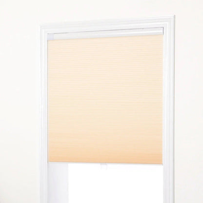 No-drill honeycomb shades in beige with tool-free, quick installation and cordless operation on window frame