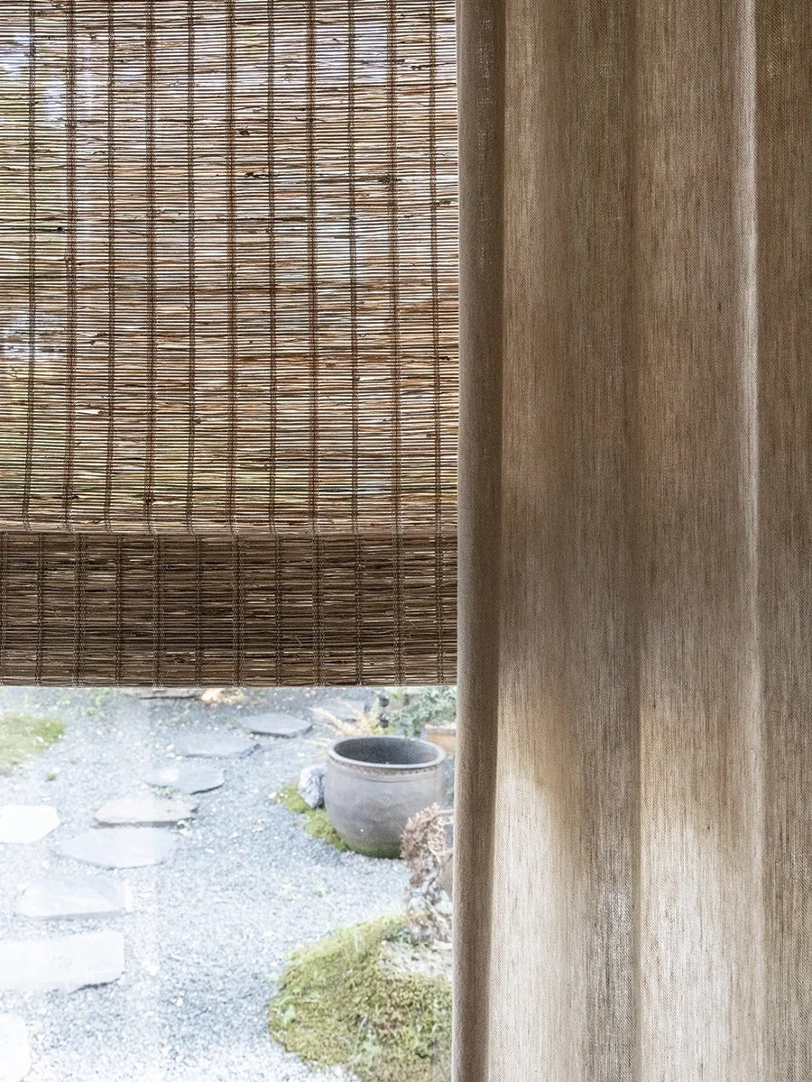 Natural jute bamboo shades in cinnamon color, handwoven with Roman folds for outdoor use