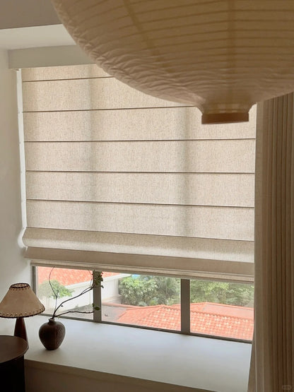 Eco-friendly sheer Roman blind in beige, showcasing cordless design with a view of a residential area, perfect for enhancing natural light in home interiors