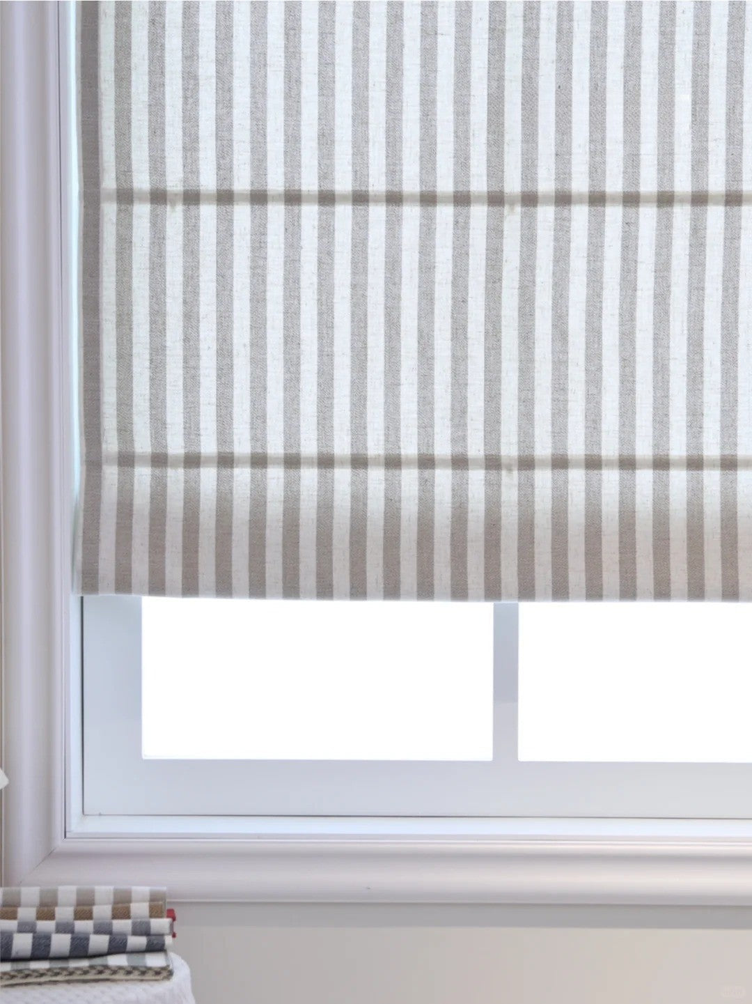 Striped Roman Shades in neutral tones with cordless lift, light filtering and blackout options, classic fabric texture for versatile window treatment