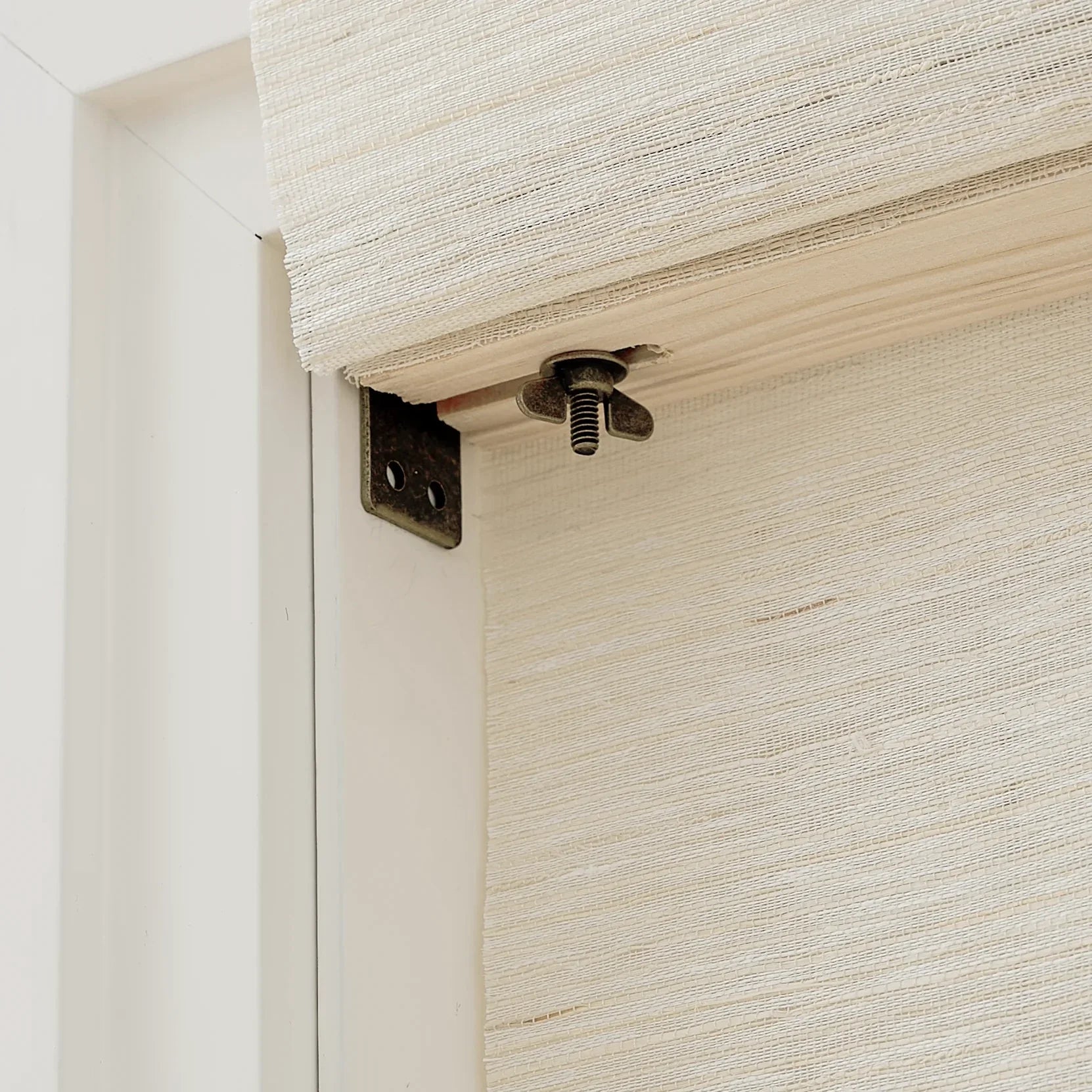 Natural Ramie Bamboo Window Shades in Coconut White, exhibiting a delicate woven texture perfect for light interiors.