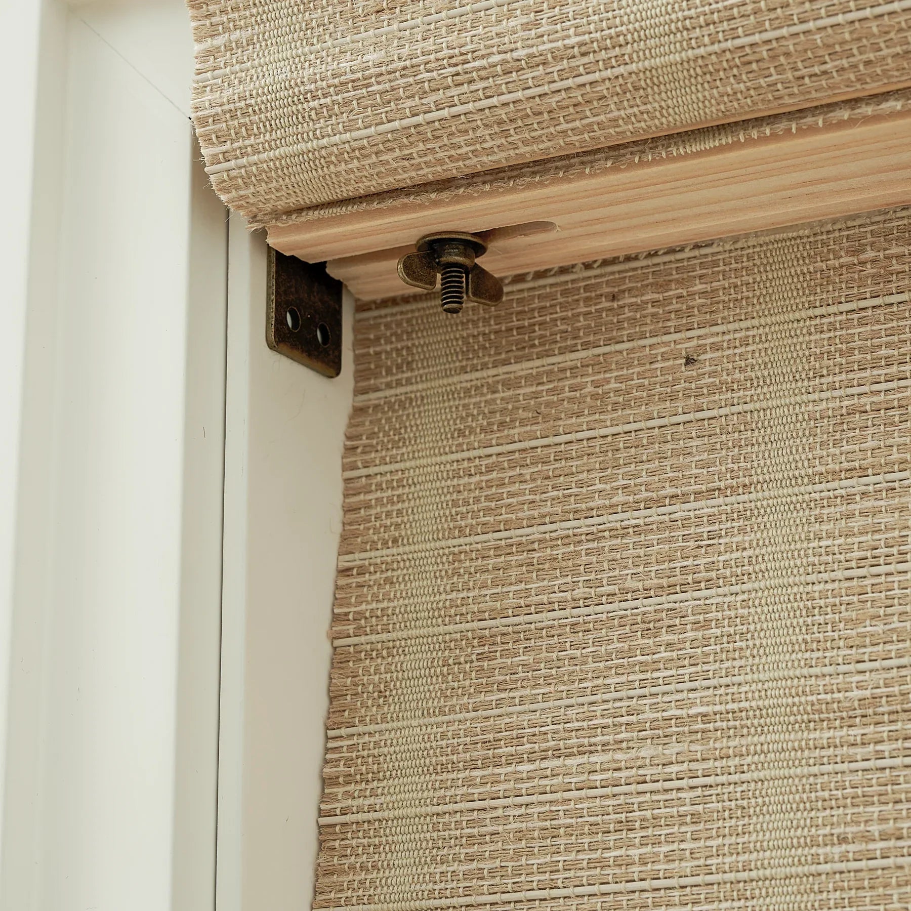 Natural jute bamboo outdoor shades in oak, showing textured woven blinds detail.