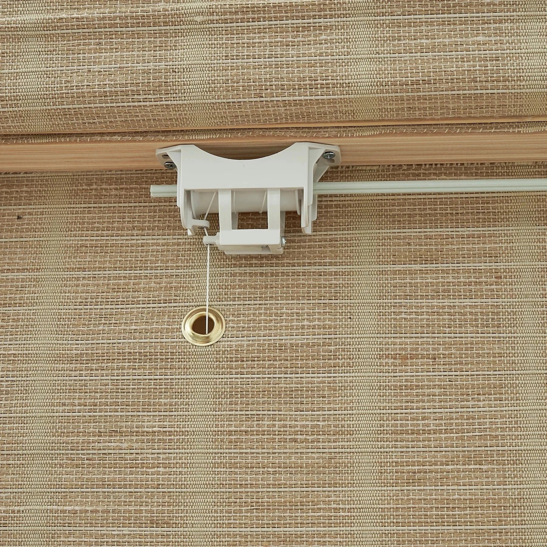 Natural jute bamboo outdoor shades in warm oak hue with woven texture.