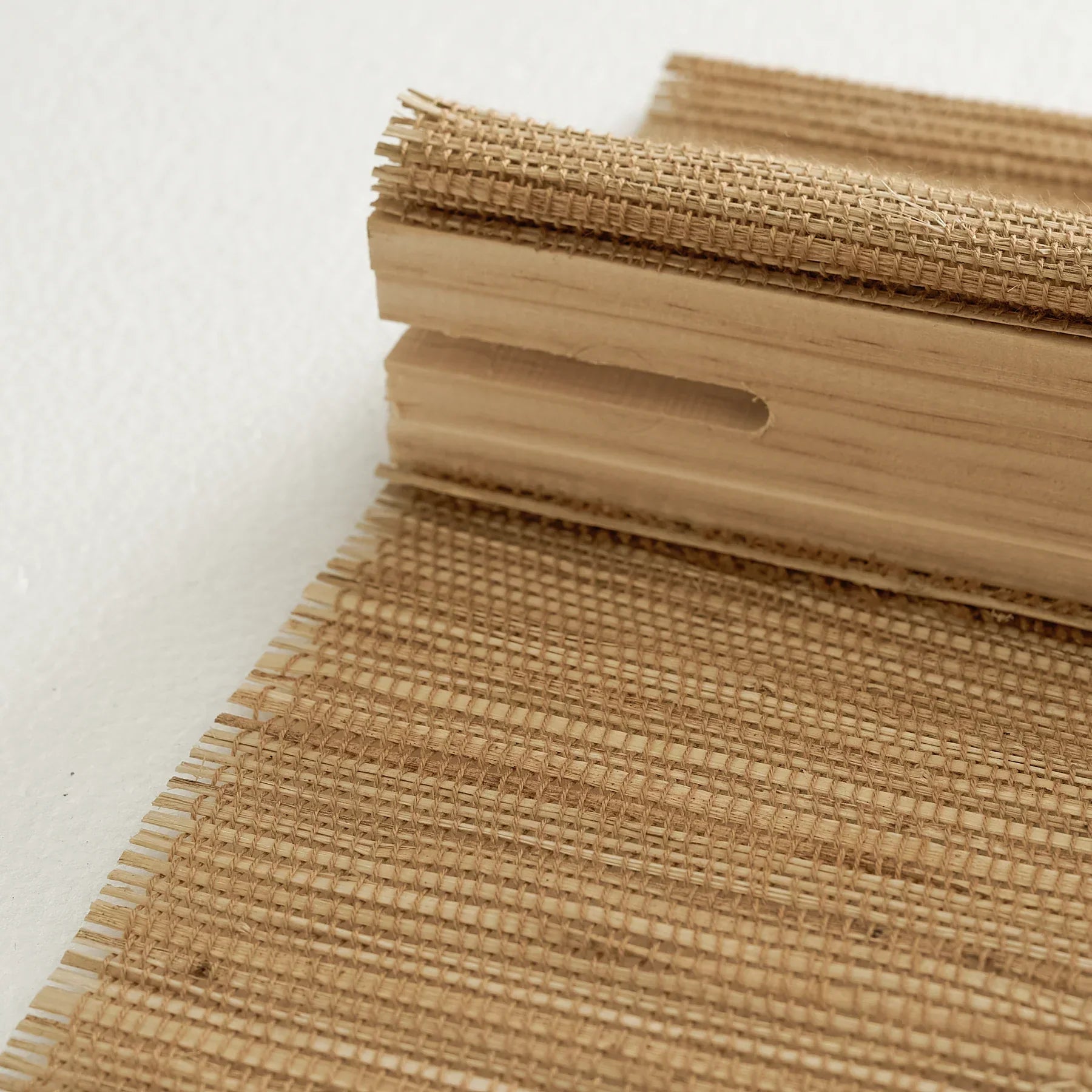 Natural hemp bamboo roman shades in bark color with woven texture.