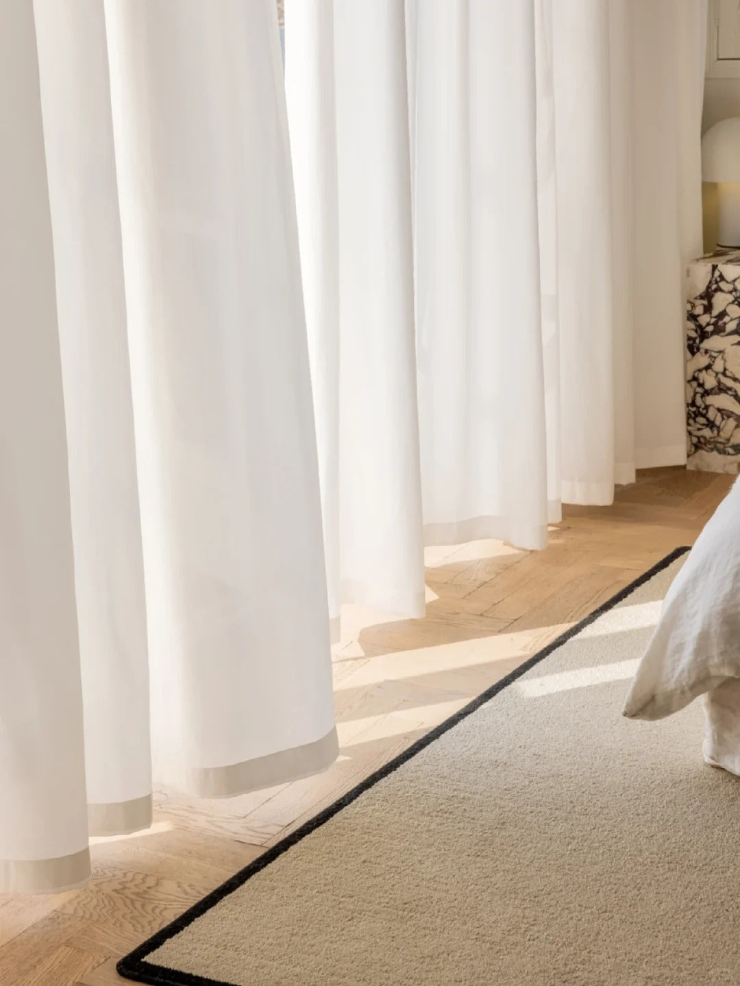 Elegant white sheer curtains in a sunlit room providing privacy and a soft ambiance, perfect for sophisticated home decor and sunlight protection