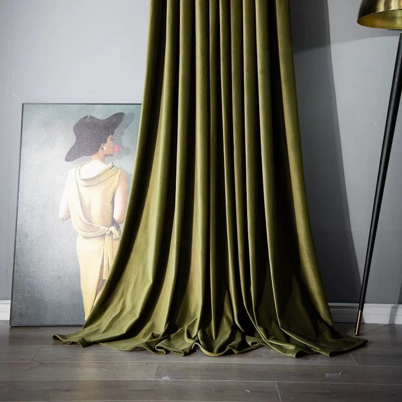 Olive green high-matte velvet drapes pooling elegantly on floor in modern living room setting