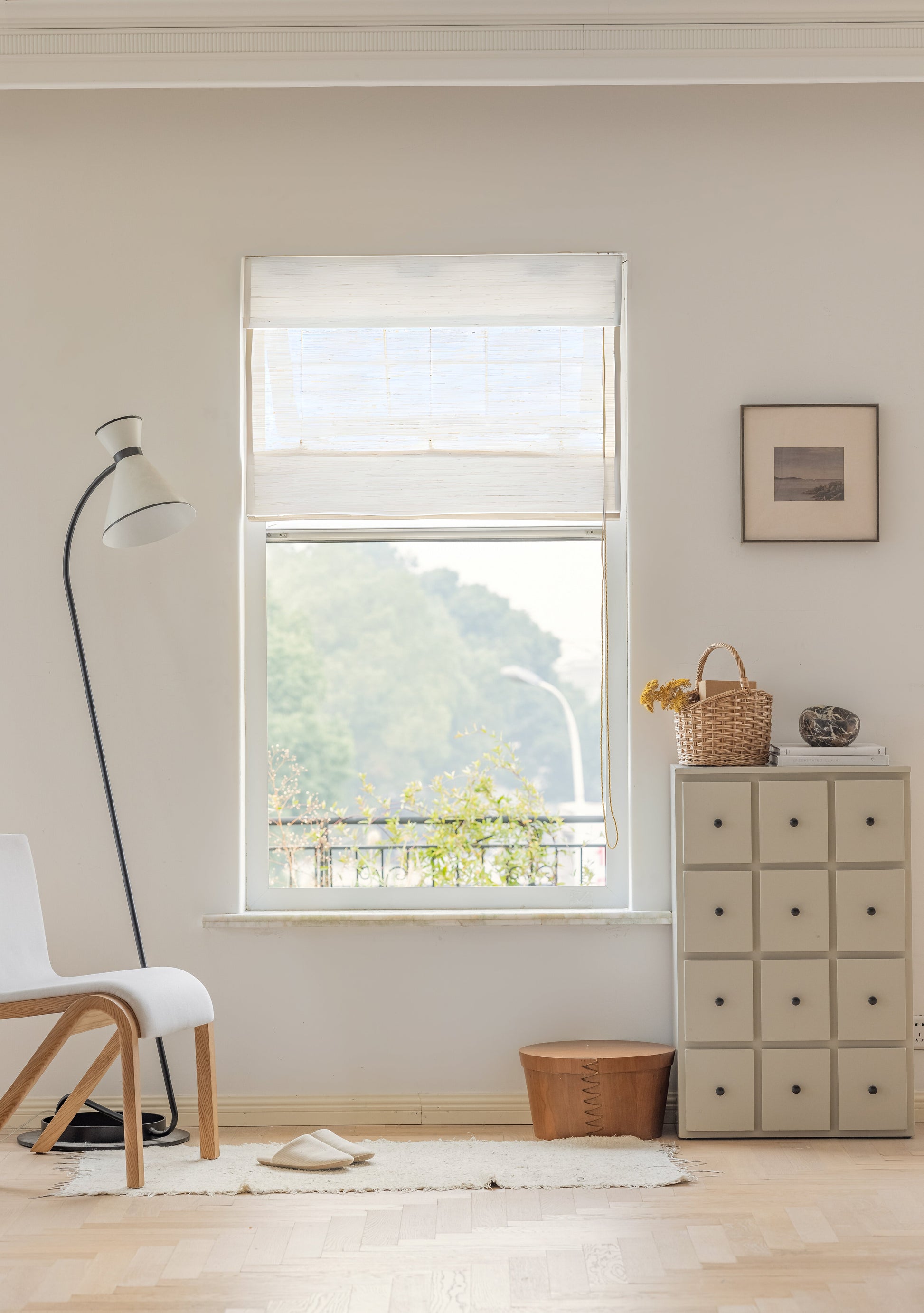 Natural ramie bamboo window shades in coconut white with delicate woven texture in a bright, minimalist room