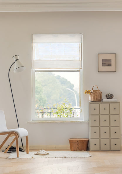 Natural ramie bamboo window shades in coconut white with delicate woven texture in a bright, minimalist room