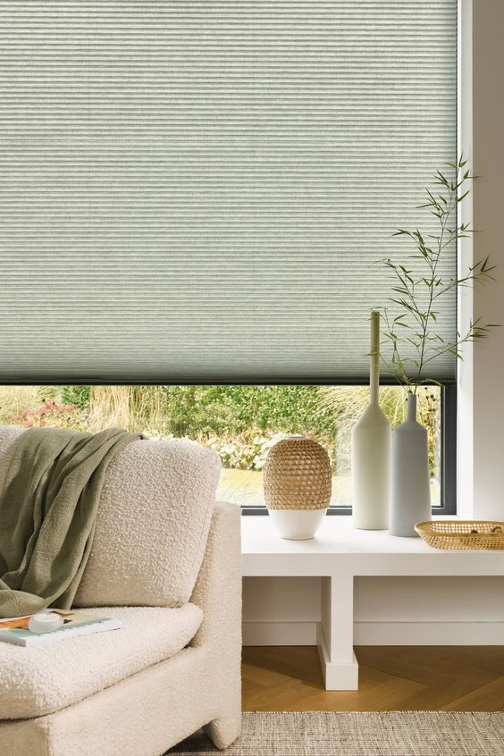 Modern interior with EaseEase 38mm premium honeycomb cellular blind fully deployed on a large window, complementing a serene living space with decorative elements