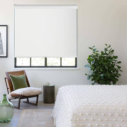 Modern bedroom with EaseEase UV Blocker Roller Blind in white, enhancing privacy and blocking sunlight next to a potted plant and minimalist furniture