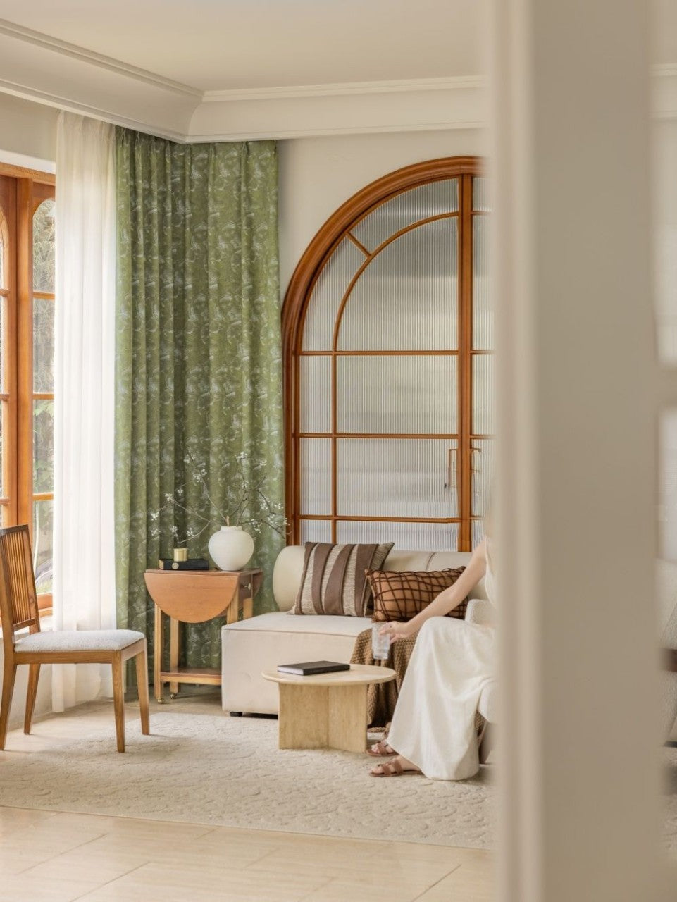 Green blackout curtains with ginkgo leaf pattern in stylish living room setting.