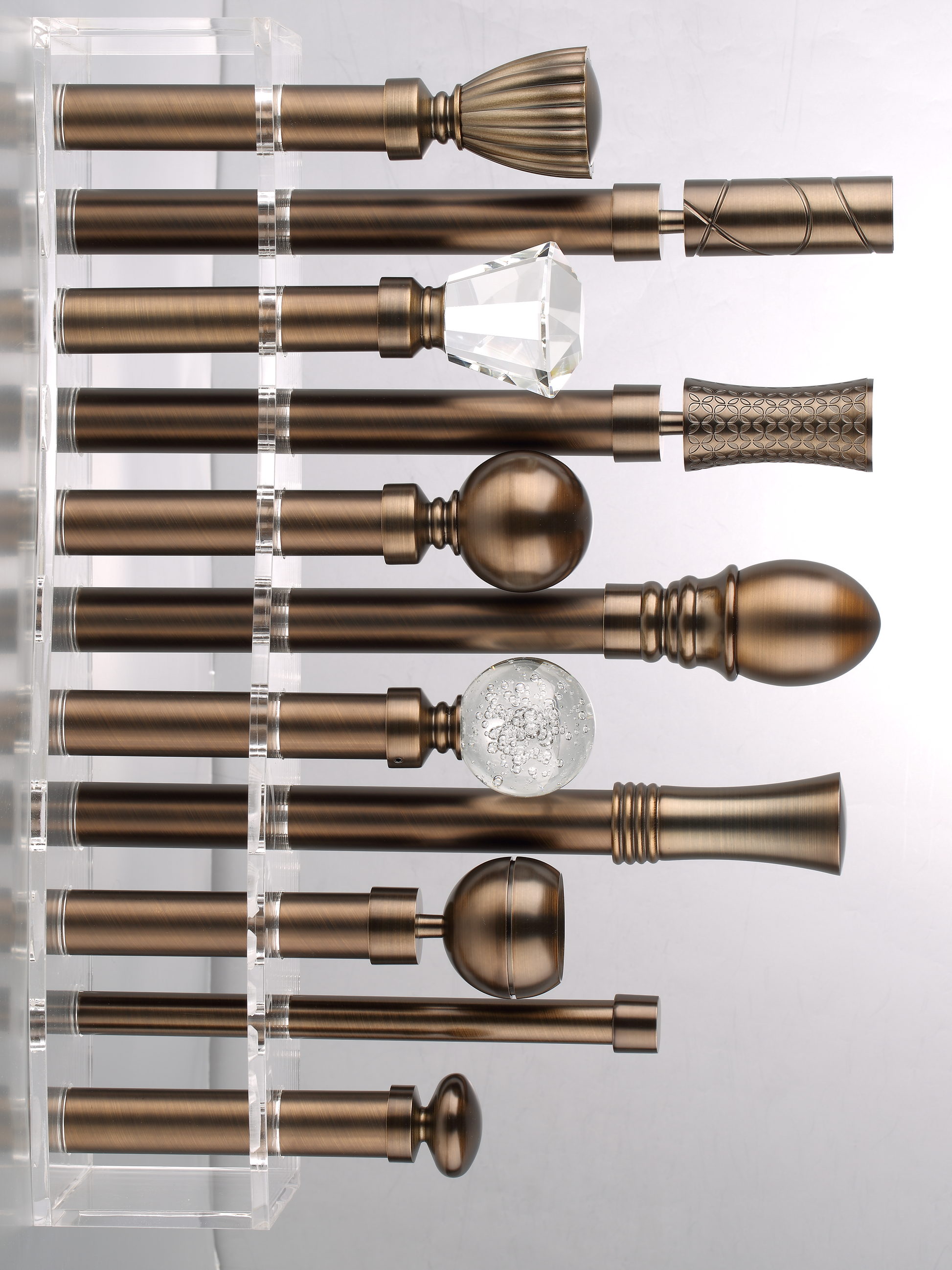 High end curtain rods with antique bronze finish, featuring various designer finials and seamless 90° corner connectors.