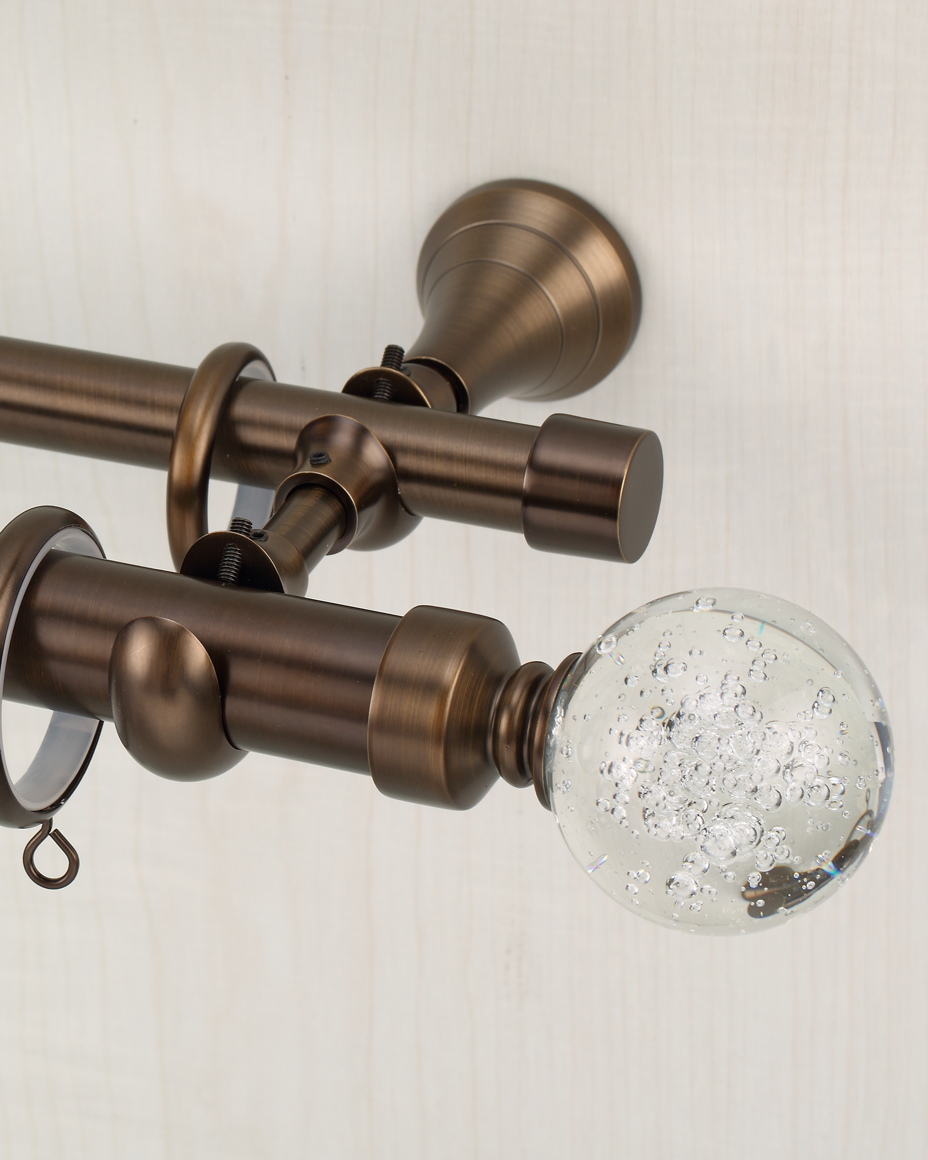 Antique bronze high end curtain rods with glass finial, designed for smooth drape movement and 90-degree corners.