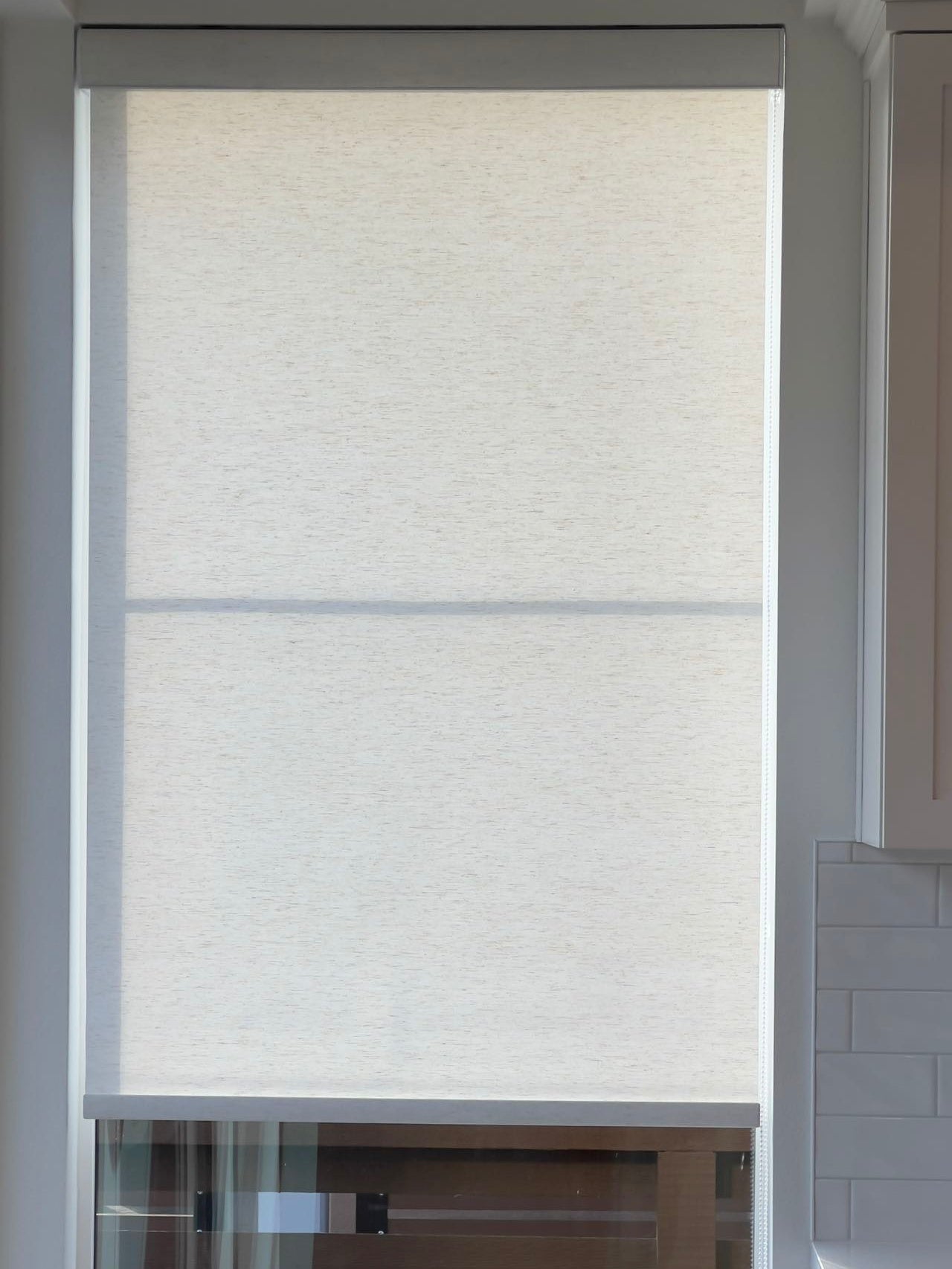 Semi-blackout linen roller shade, offering privacy