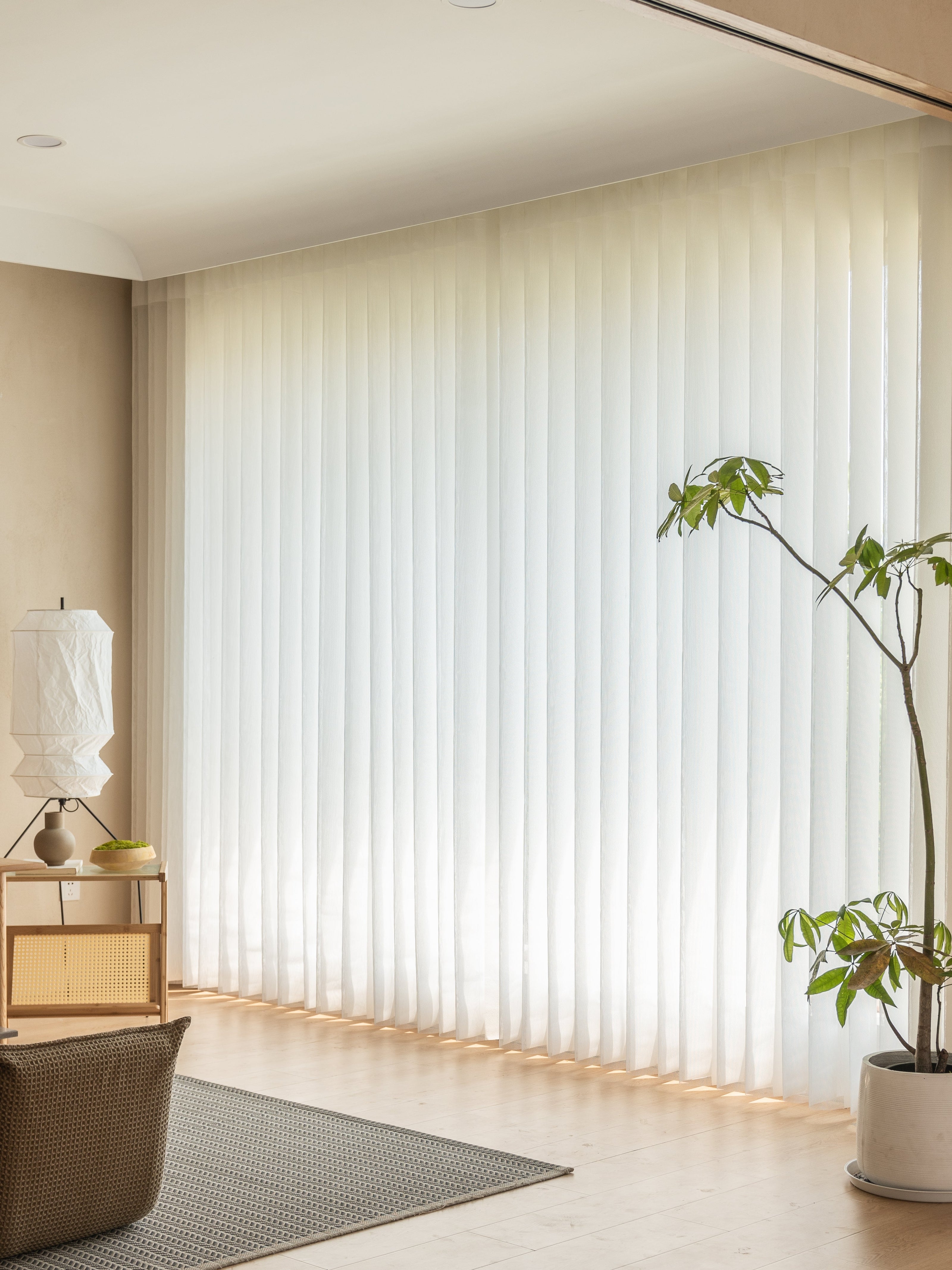 Sheer curtain panels for large windows enhancing light diffusion in a modern living room.