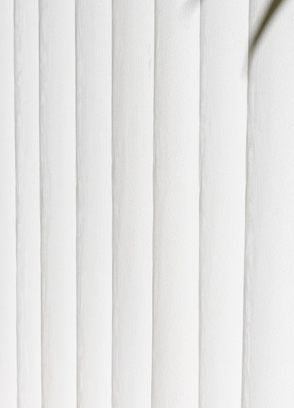 A close up of a white window with blinds, crafted from a unique blend of fabric and sheer for light-filtering and transparency.