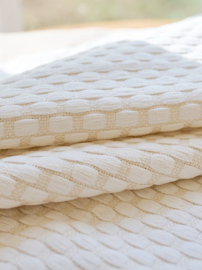 Close-up of heavyweight blackout curtains with a pearl drop texture, designed for noise cancelling and heat blocking.