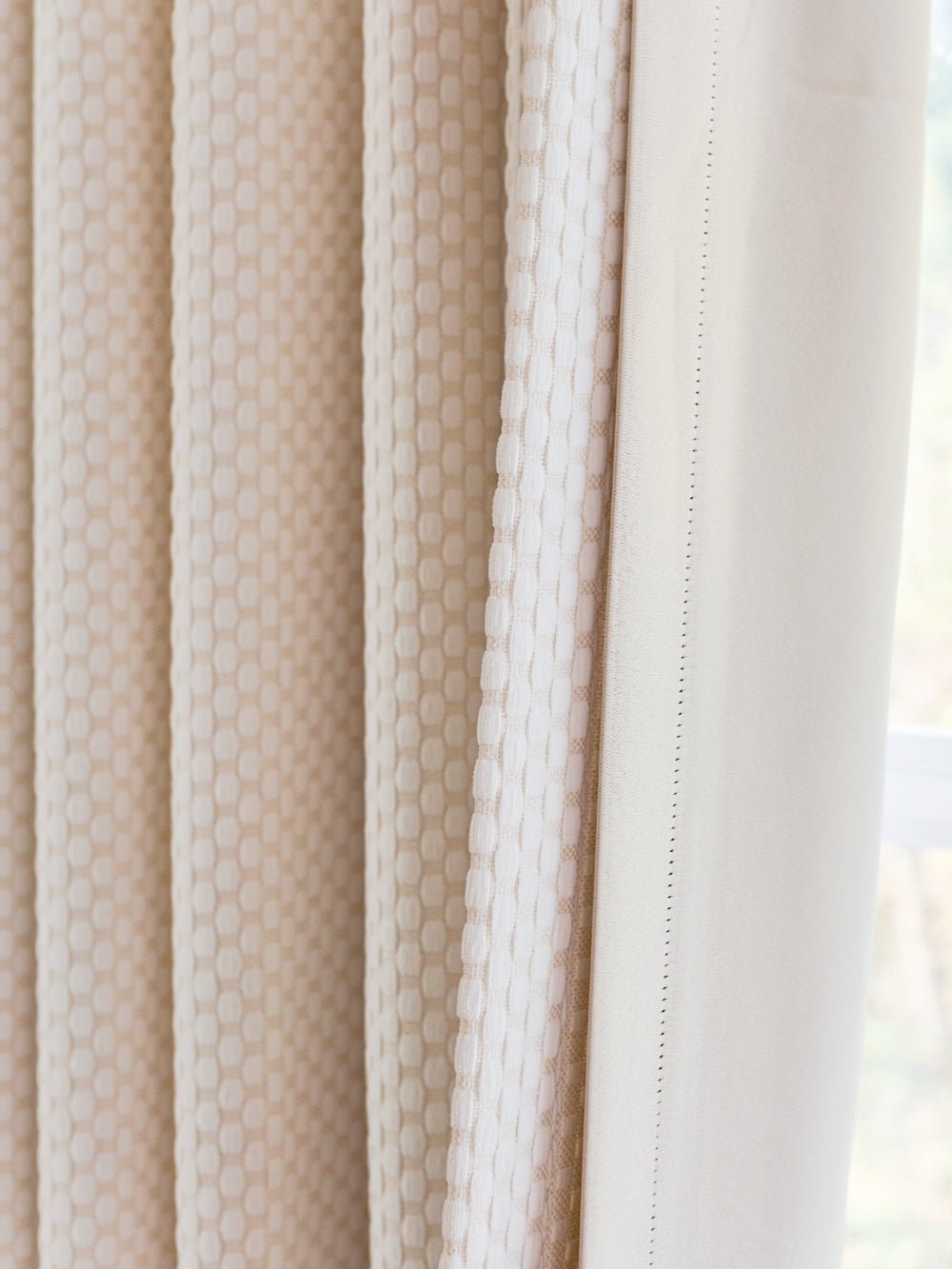 Heavyweight blackout noise cancelling curtains with elegant pearl-inspired design.