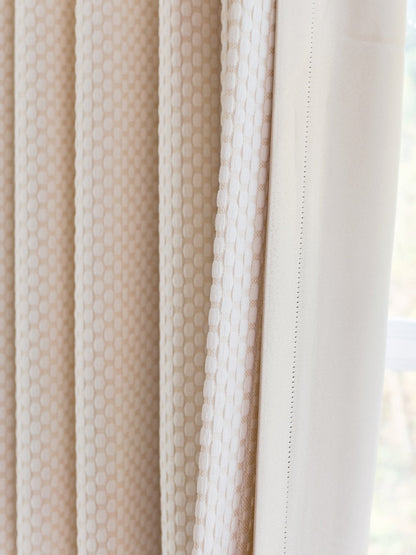 Heavyweight blackout noise cancelling curtains with elegant pearl-inspired design.