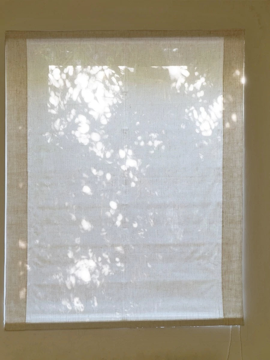 Light filtering relaxed Roman shades with soft, sheer linen, allowing gentle sunlight diffusion.