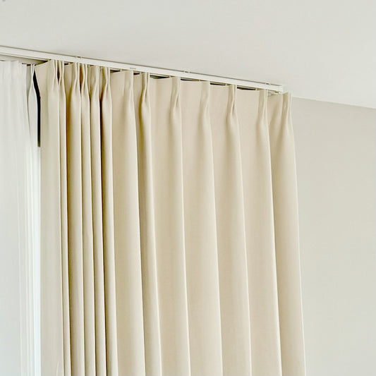 Beige curtain on window with ultra-thin silent invisible track, sleek design and whisper-quiet operation.