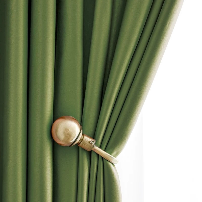 green silk curtains with elegant smooth draping and gold curtain tieback