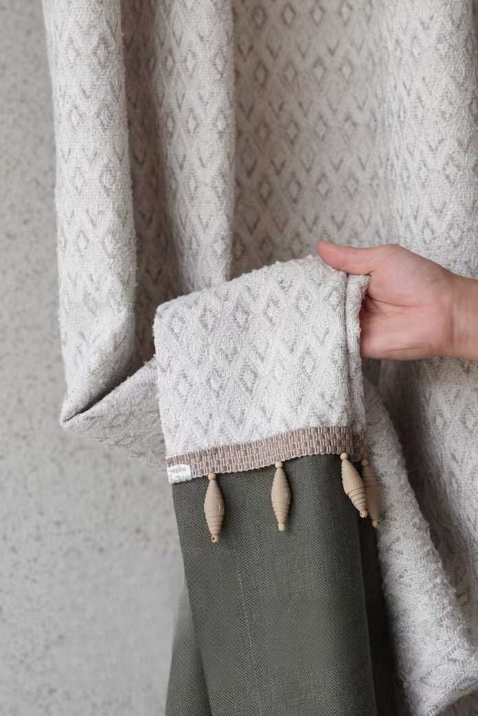 Vintage curtains with textured fabric and tassel details.