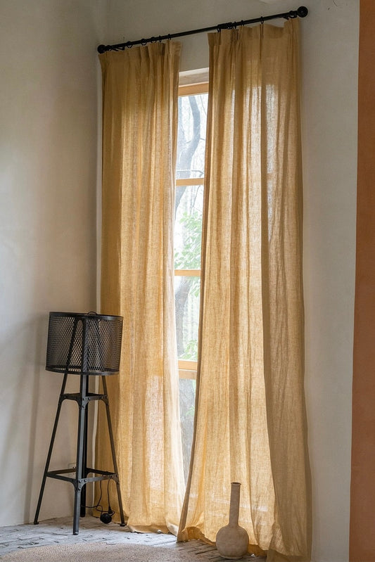 Pale yellow pure linen curtains elegantly hanging in a room with natural lighting, showcasing luxurious texture and subtle transparency provided by French-imported linens from EaseEaseCurtains