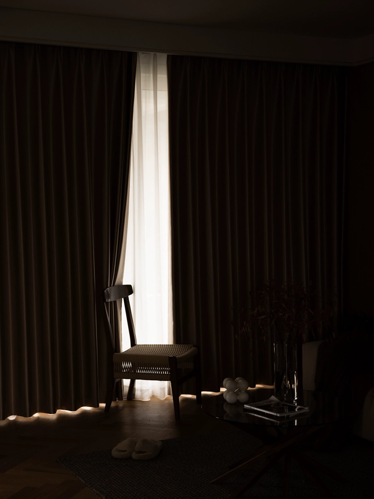 Elegant silk curtains in a dimly lit room, showcasing smooth draping and luxurious ambiance.