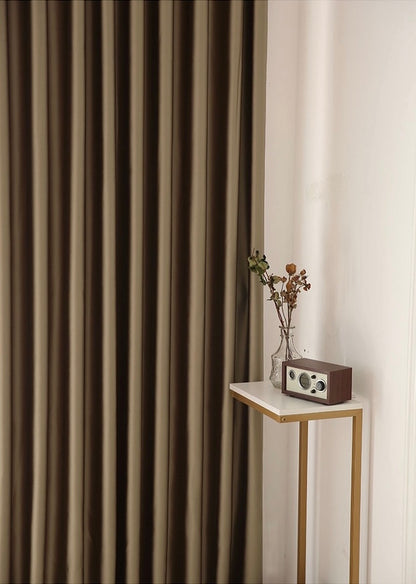 Elegant brown silk pleated curtain from EaseEaseCurtains beside a minimalist decor setup with a gold end table, retro radio, and a vase with dried branches