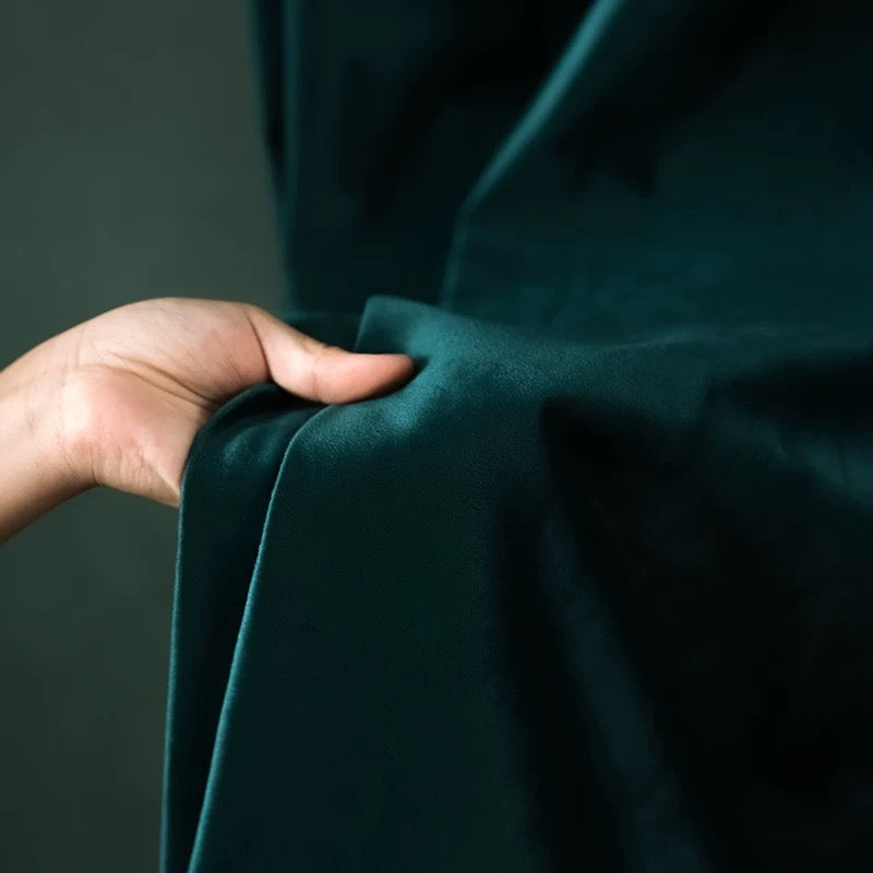 Luxurious soft-sheen velvet drapes in creamy tones enhancing living room elegance