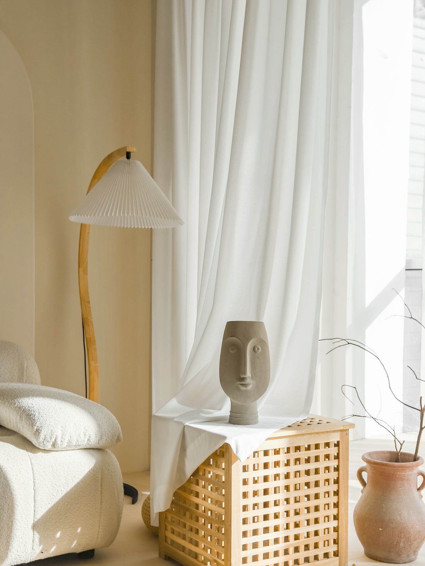 Premium white sun-blocking sheer curtain with waffle pattern in stylish room setup with floor lamp and decorative sculpture