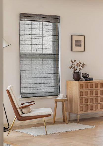 Natural ramie bamboo woven shades with black stripes in minimalist living room setting