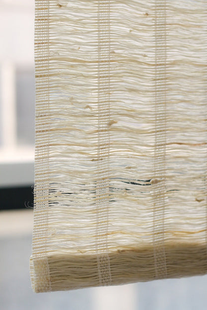 Natural almond-colored ramie woven wood shades with breathable handwoven texture filtering soft light