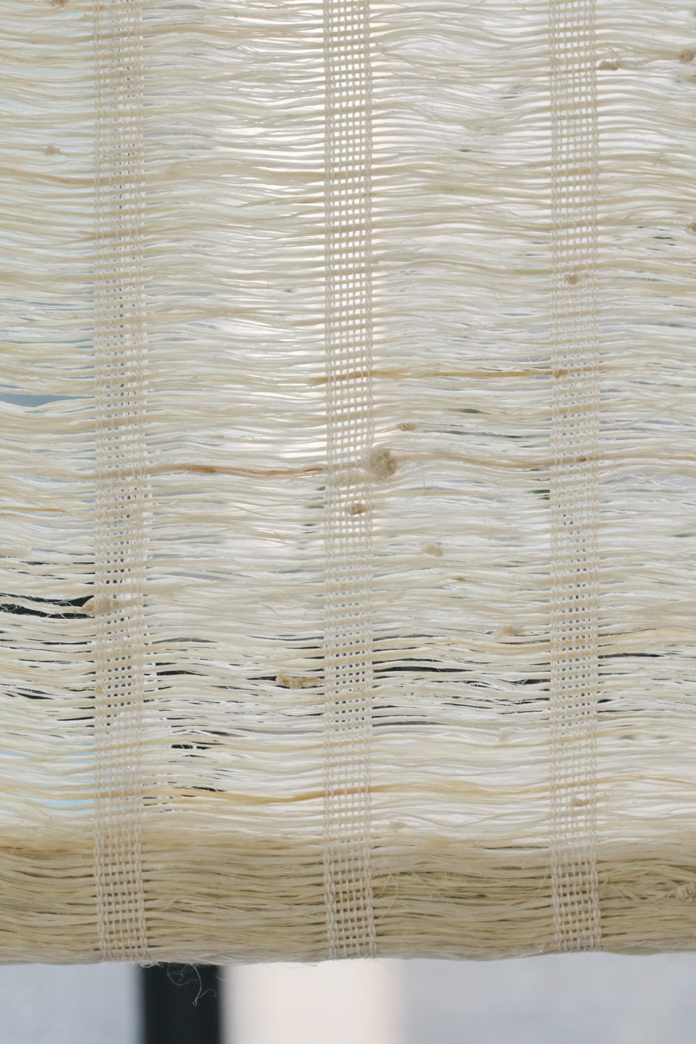 Almond-colored natural ramie woven wood shades with breathable texture and handwoven craftsmanship