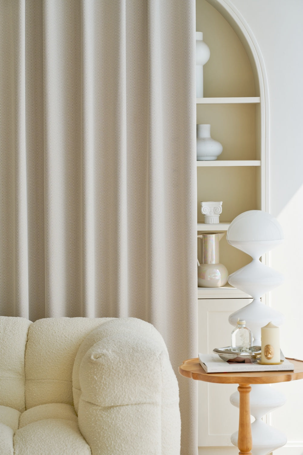An elegant room featuring a white couch and table, enhanced by a stylish EaseEase Herringbone Pattern Chenille Curtain.