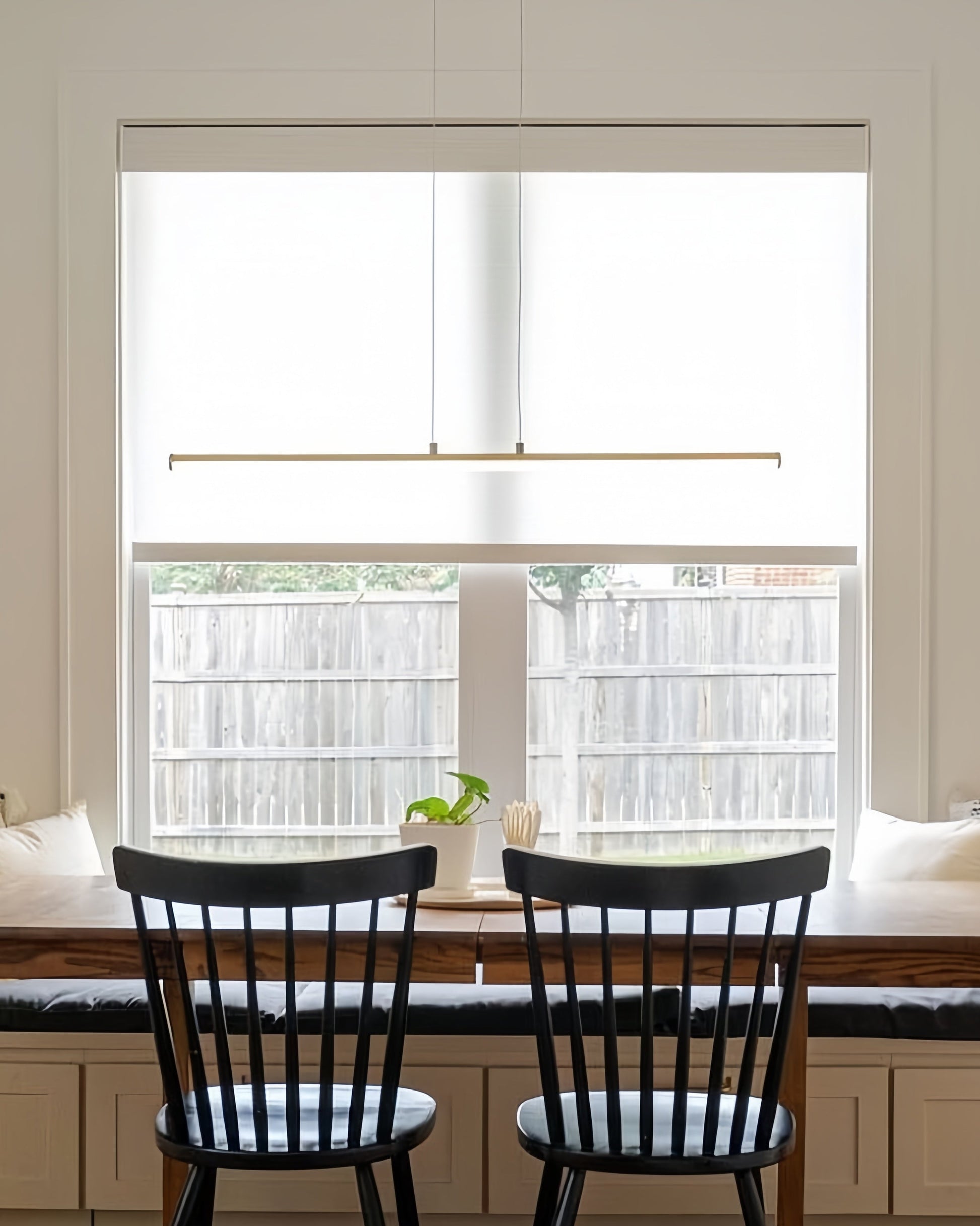 Solar shades on a window, UV blocking cordless roller blinds, modern design.