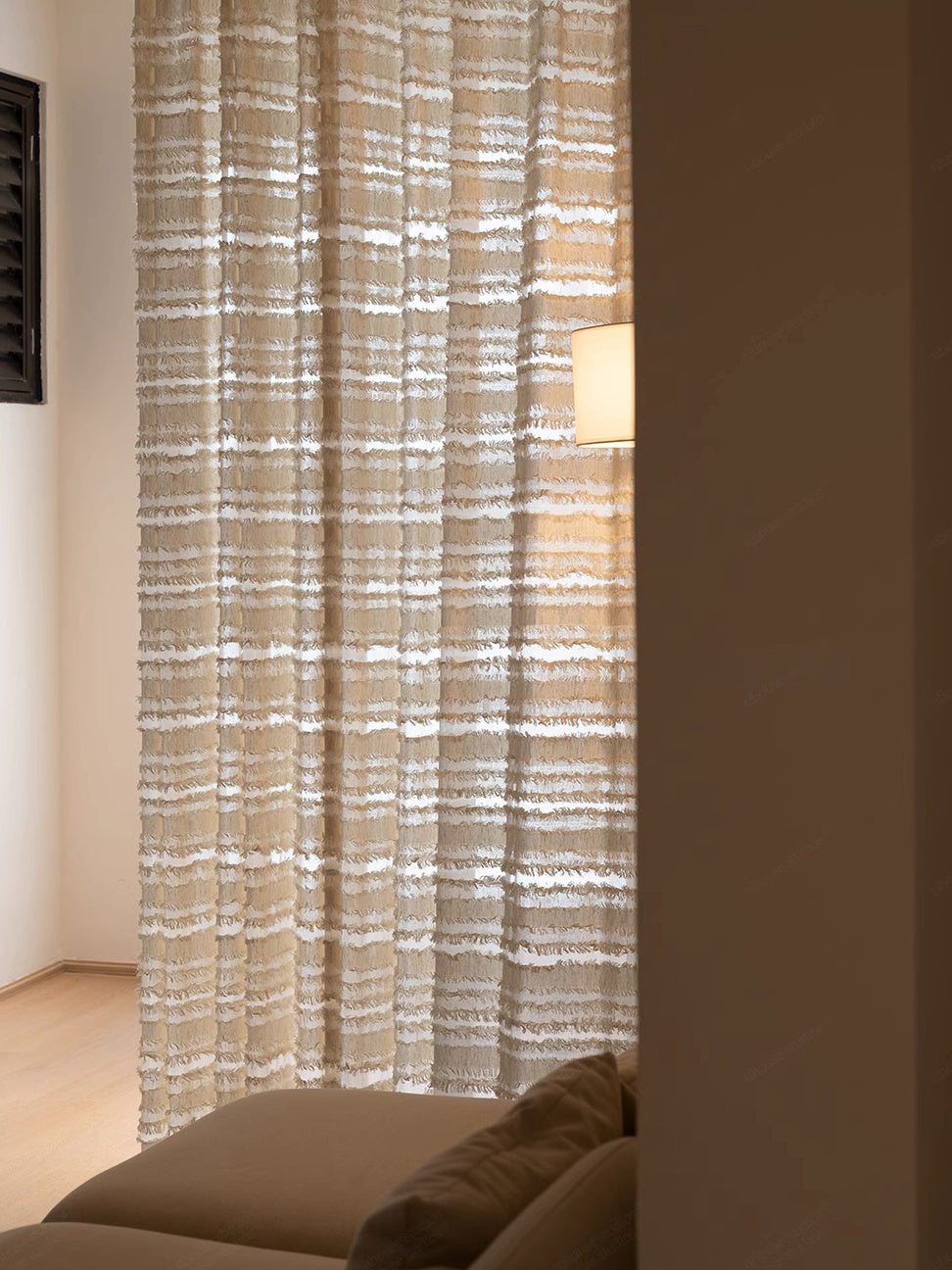 "Mousse Cake" sheer curtains with handcrafted fringe detail in a living room setting.