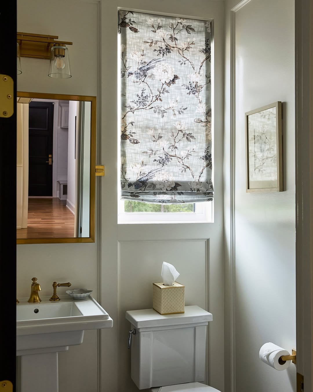 Patterned fabric Roman shades with light filtering in a bathroom setting.