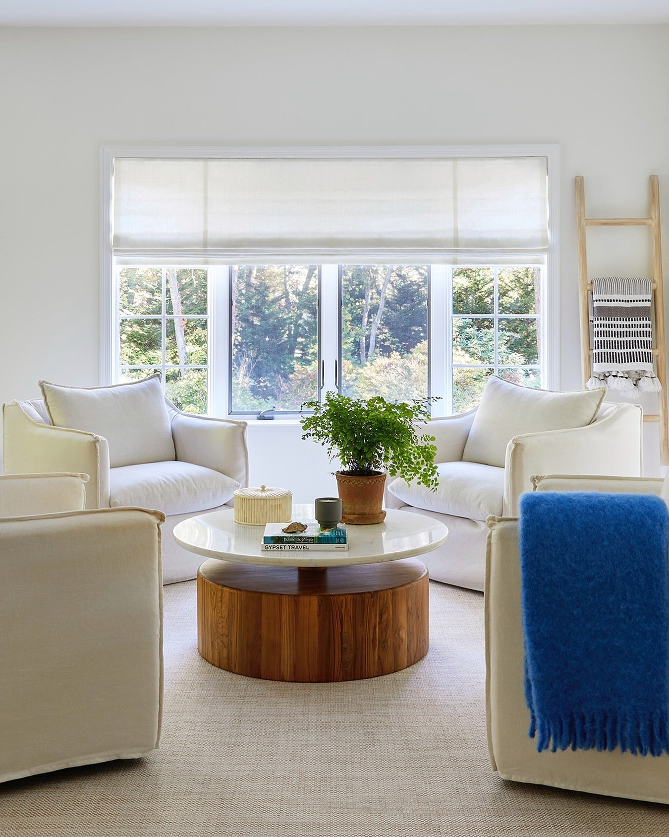 Patterned fabric Roman shades in a cozy living room setting.